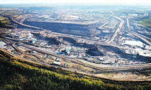 SEPT. 19, 2011 FILE PHOTO; FILE - This Sept. 19, 2011 file photo shows an aerial view of a tar sands mine facility near Fort McMurray, in Alberta, Canada. Alberta has the world's third-largest oil reserves after Saudi Arabia and Venezuela - more than 170 billion barrels. Daily production of 1.5 million barrels from the oil sands is expected to increase to 3.7 million in 2025, which the oil industry sees as a pressing reason to build the pipelines. A European Union committee failed Thursday Feb. 23, 2012 to reach a definite decision on labeling oil derived from oil sands as worse for climate change than crude oil _ a proposal vigorously opposed by officials in Canada, where such oil is produced. (AP Photo/The Canadian Press, Jeff McIntosh, File)